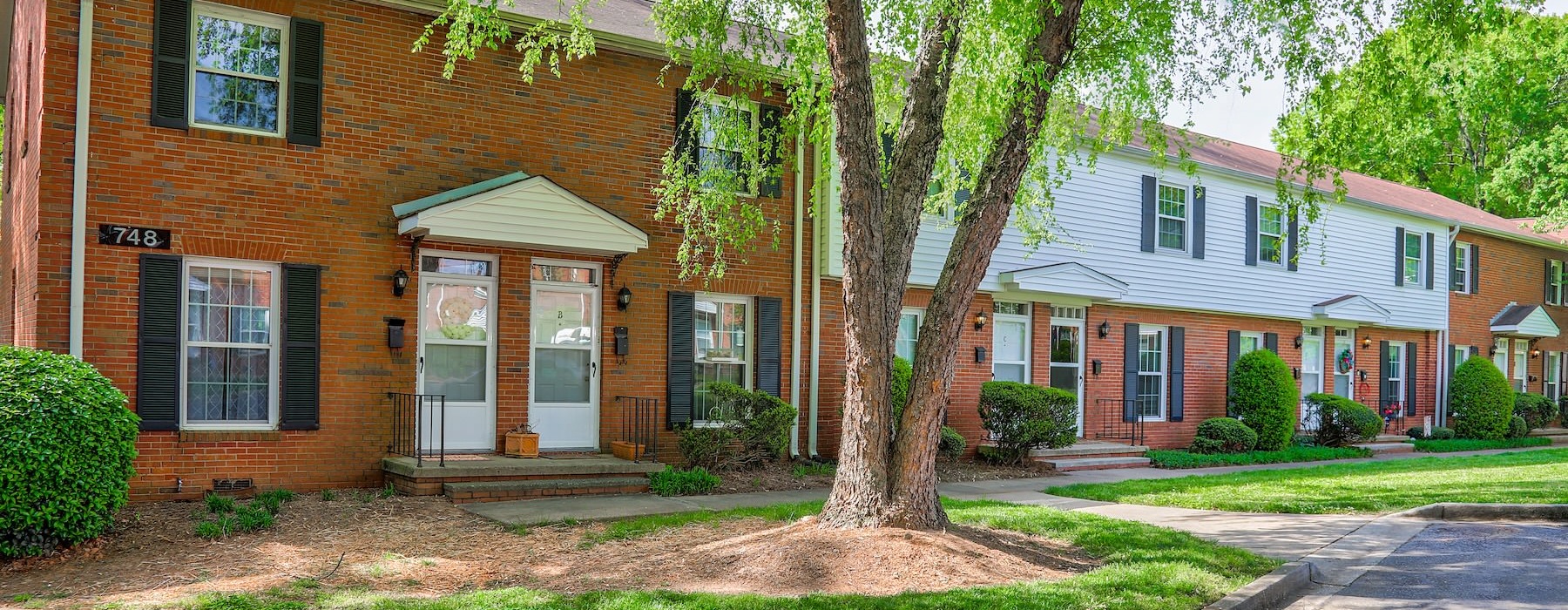 a brick building with a tree in front of it