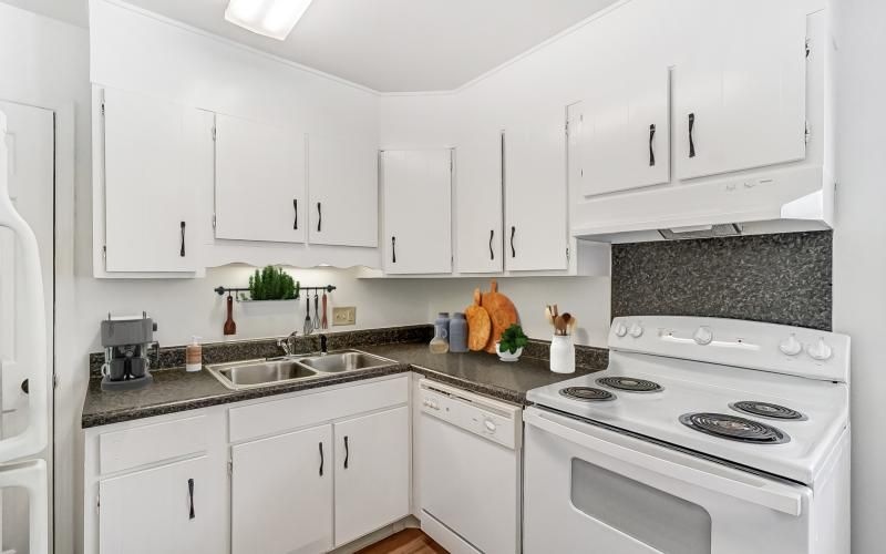 a kitchen with white cabinets