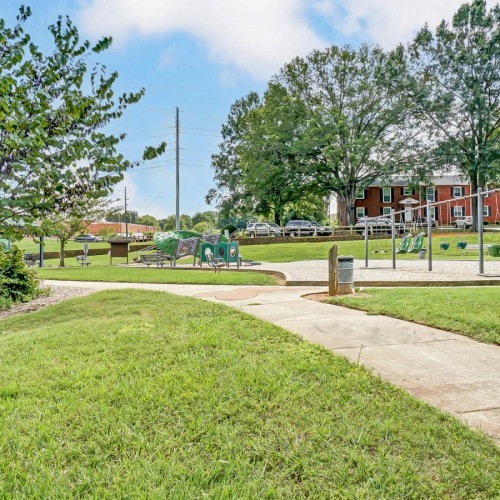 a path with grass and trees